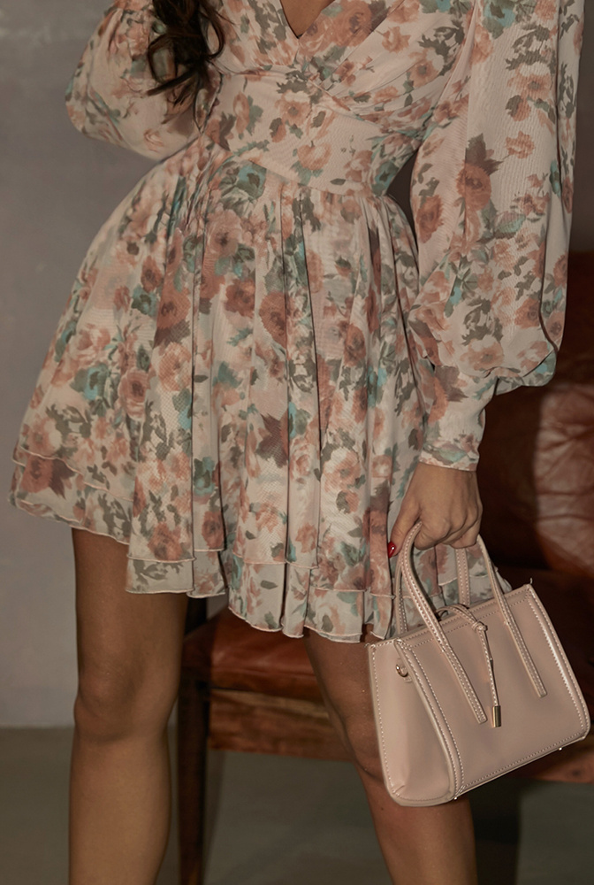 Laila - a mini dress in a shade of dirty pink with a floral print