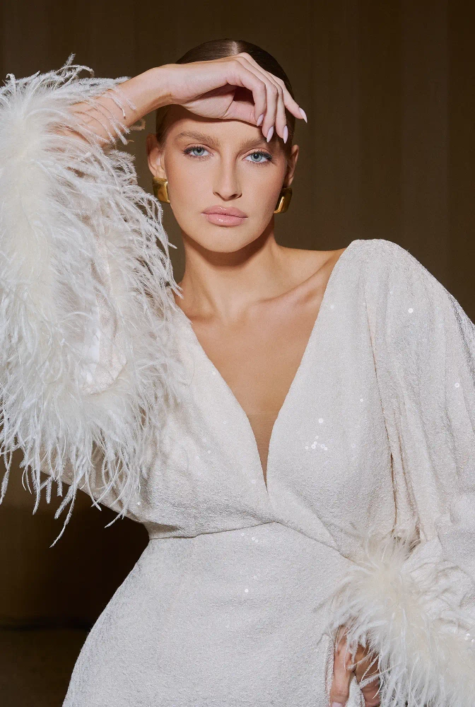 																							Toluca – ecru mini dress with sequins and feathers
																					